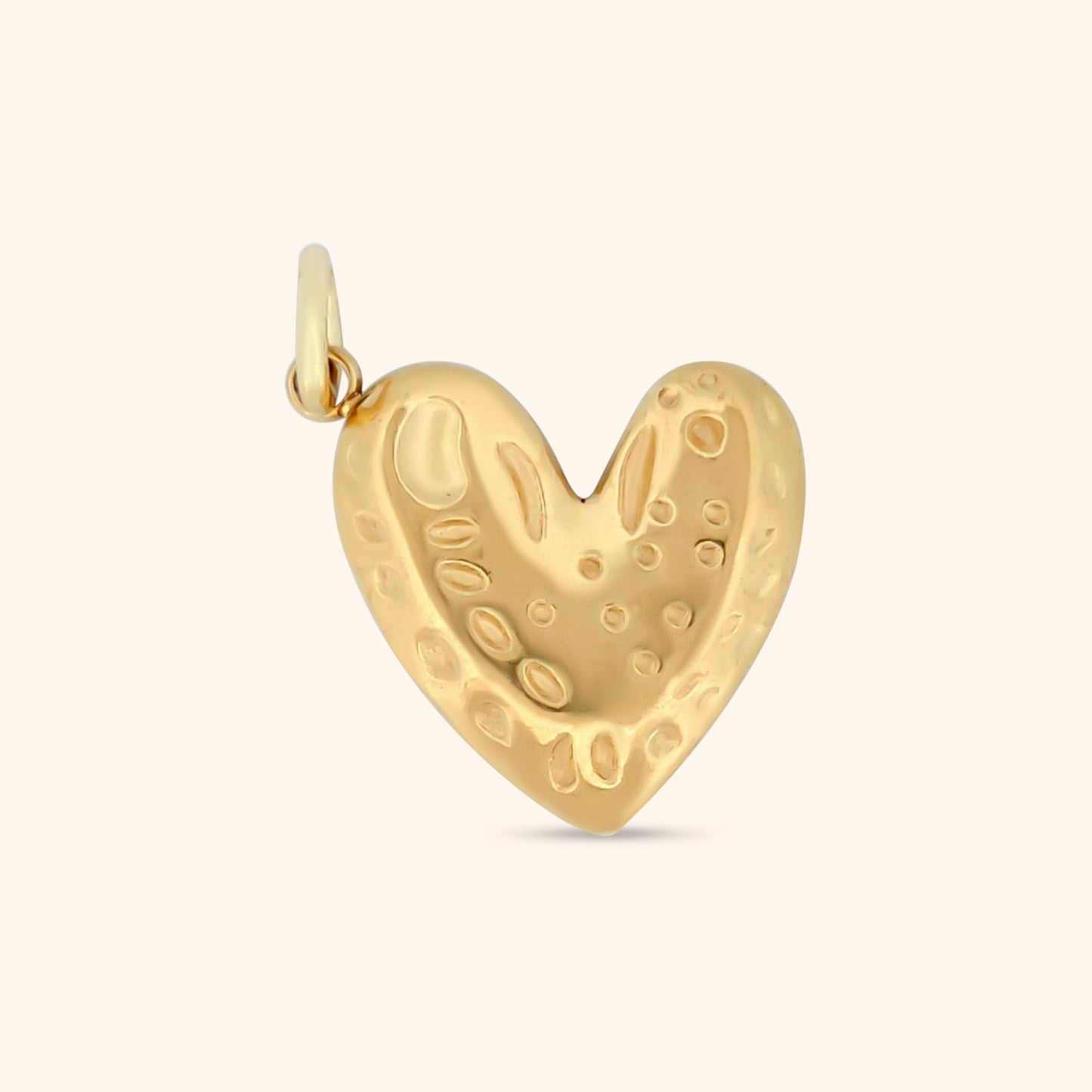 Close-up of the Amour Charm, a gold heart-shaped charm with a textured surface.