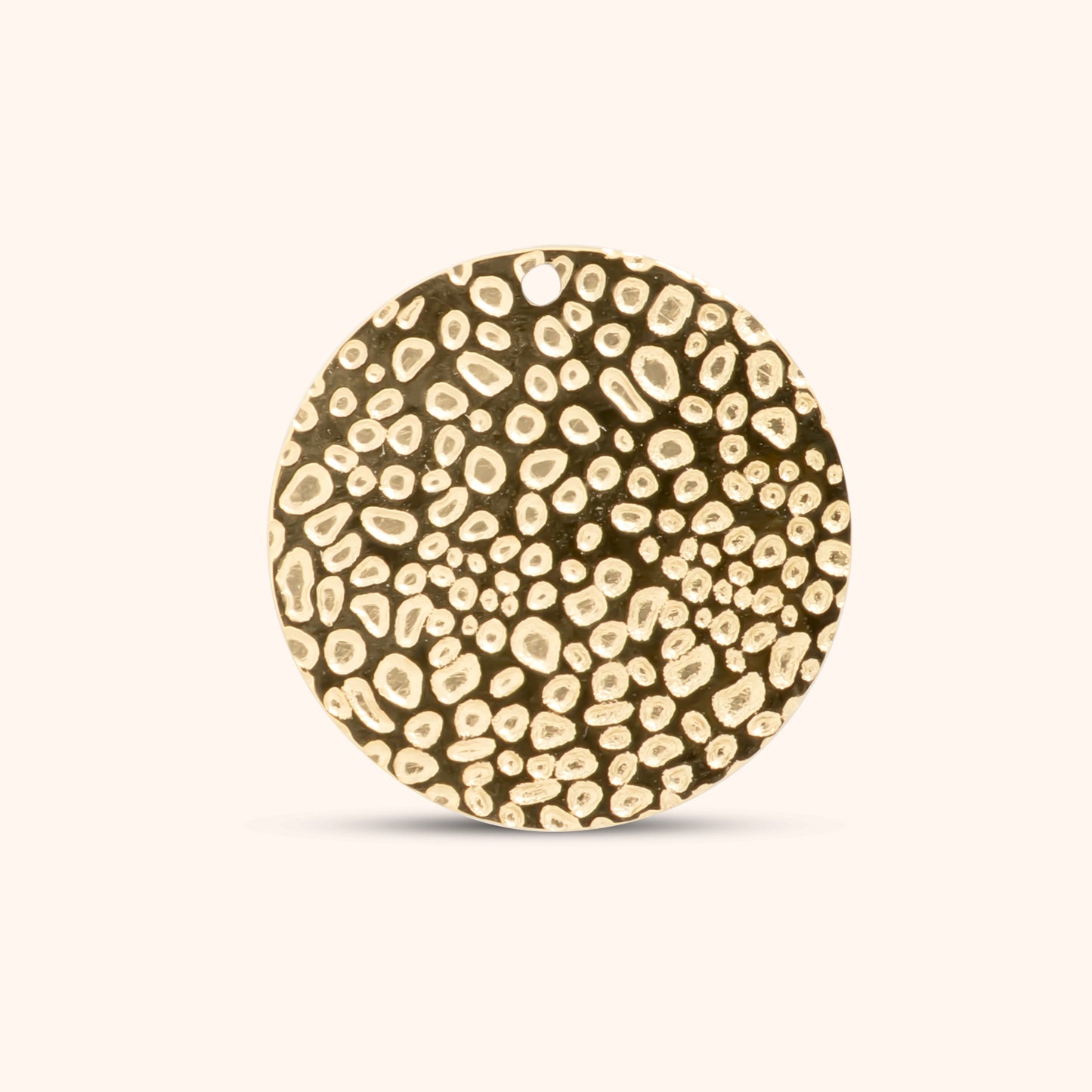 PRESSIE Pebble Disc Charm; an 18k gold plated round charm with a distinctive abstract, textured surface resembling dense, irregular pebbles, with a top hole for attachment.