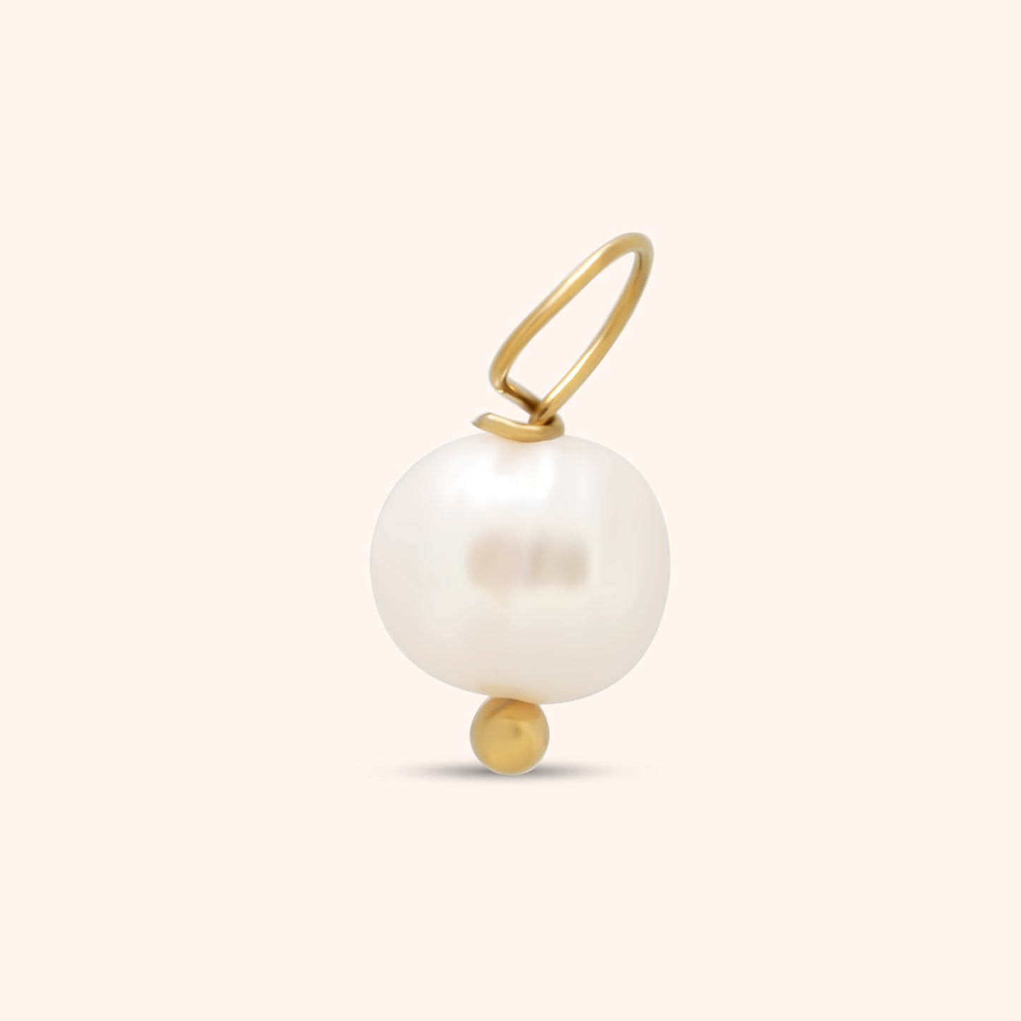 White freshwater pearl charm with small gold bead base and gold loop, photographed on a neutral background