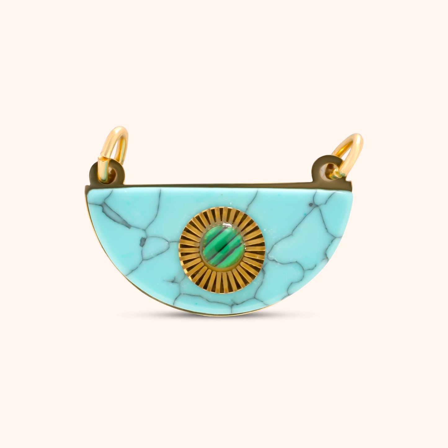 PRESSIE Horizon Charm; an 18k gold plated semi-circular charm made of light blue marbled stone, featuring a central gold sunburst medallion with a small green cabochon stone inset, and two top bails.