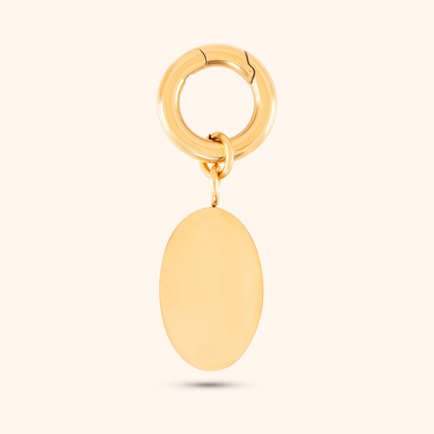 Close-up, rear view of a PRESSIE gold-plated, oval-shaped pendant showing its smooth texture.