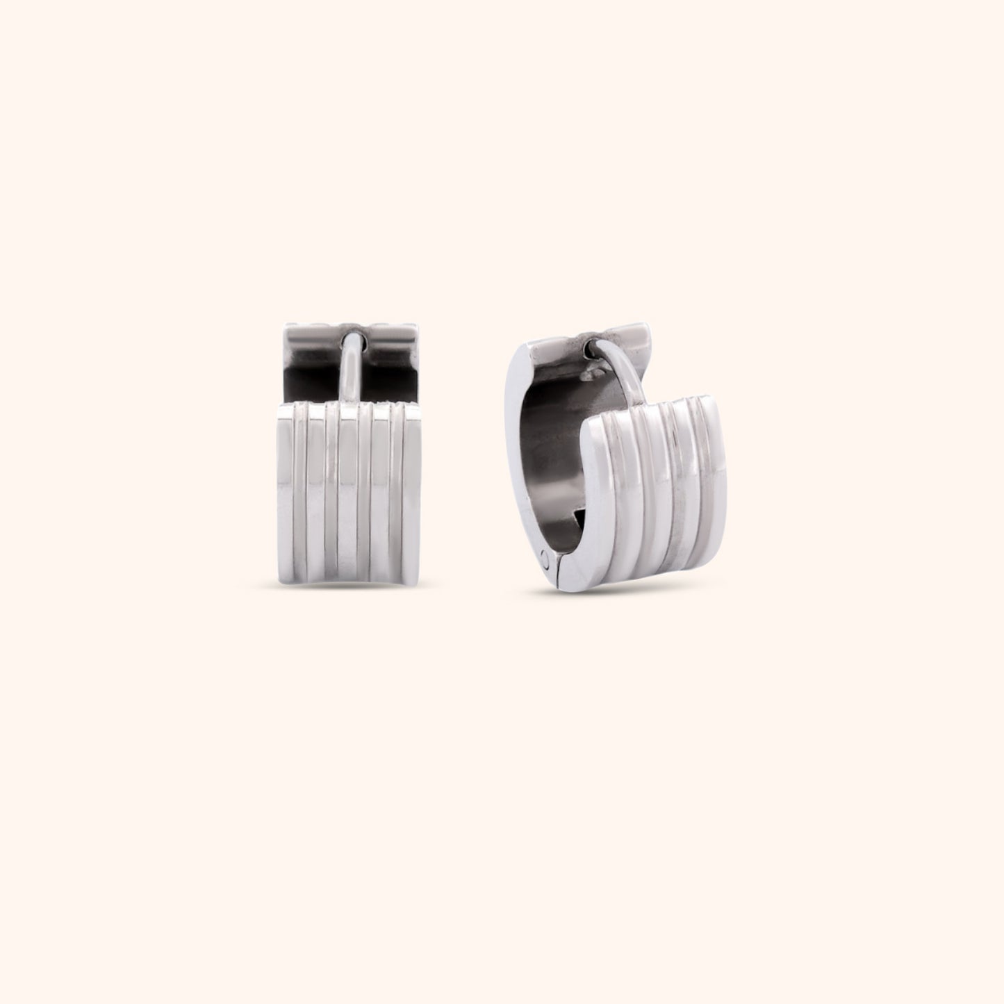 Pair of gold ribbed huggie earrings, highlighting their elegant and modern style.