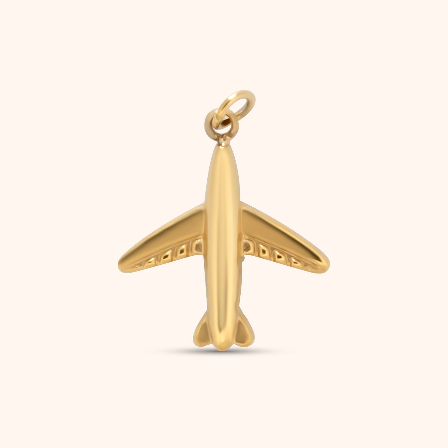 Gold airplane-shaped charm with smooth finish and rounded details, made of 18k gold plated stainless steel