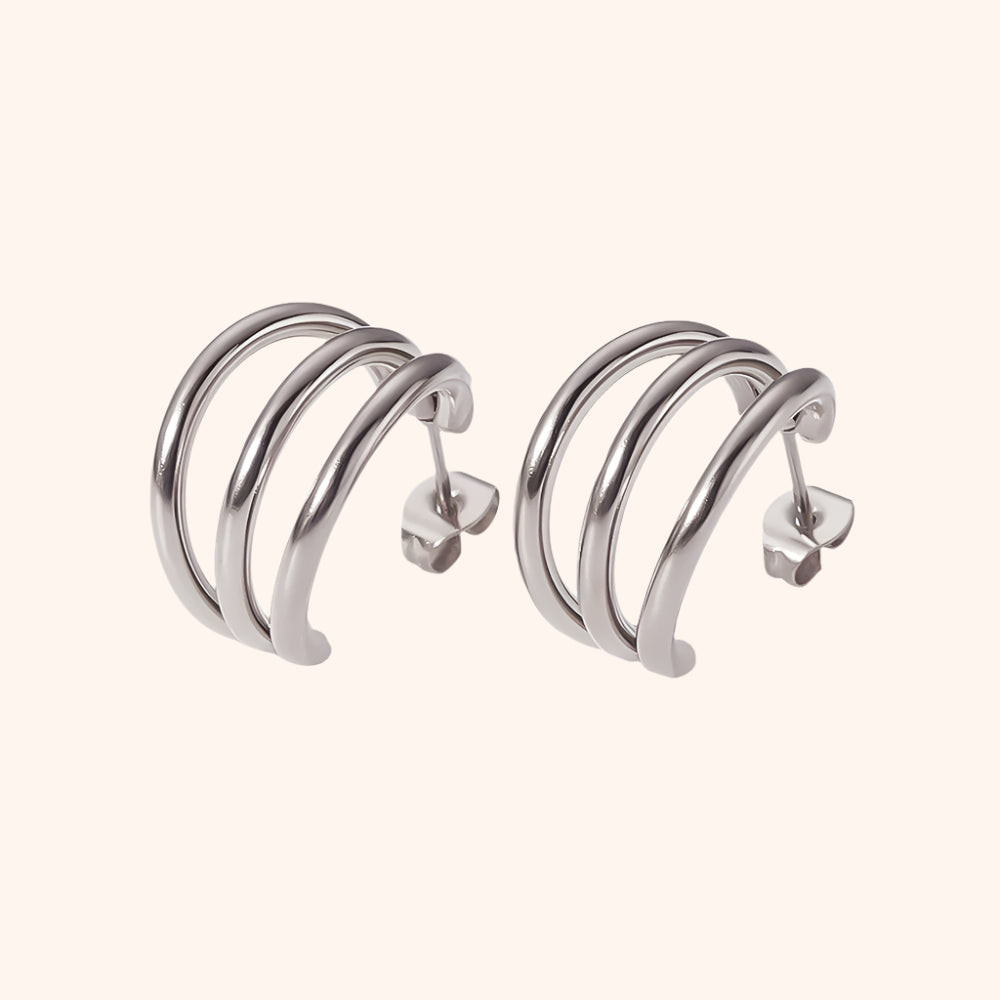 Pair of silver hoop earrings on a white background