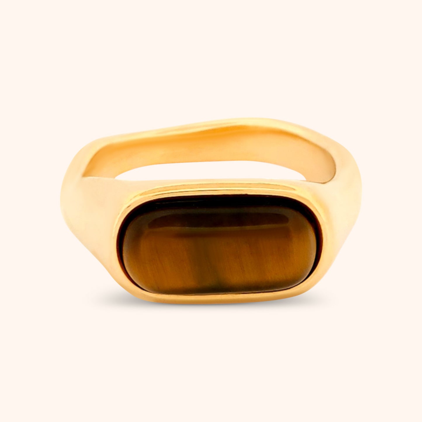 Close-up of the Marbella Ring, showcasing its earthy-toned Tiger's Eye oval centerpiece and sleek gold band against a clean white background.
