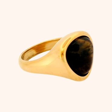 Angled view of the Idar Ring with a Tiger's Eye gemstone, highlighting the sleek gold band and the stone's rich, warm tones.
