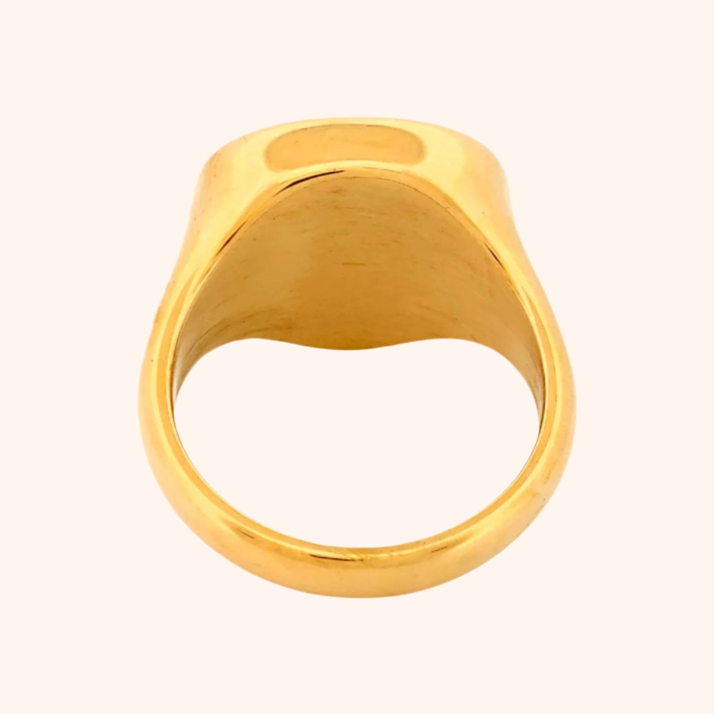 Close-up of the Idar Ring, a gold ring featuring a Rose Quartz gemstone, showcasing its soft blush pink color and smooth, polished surface.
