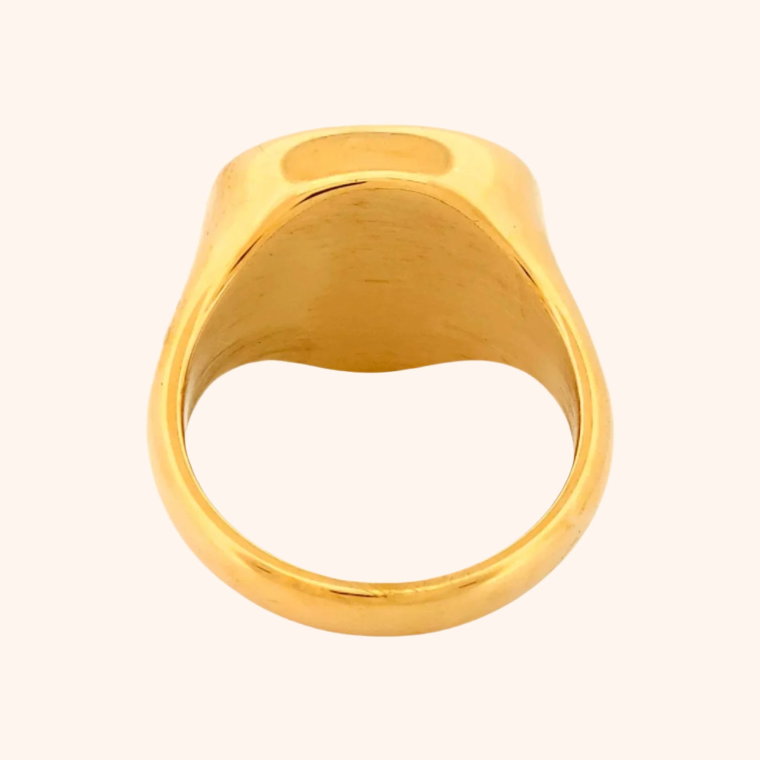 Close-up of the Idar Ring, a gold ring featuring a Rose Quartz gemstone, showcasing its soft blush pink color and smooth, polished surface.
