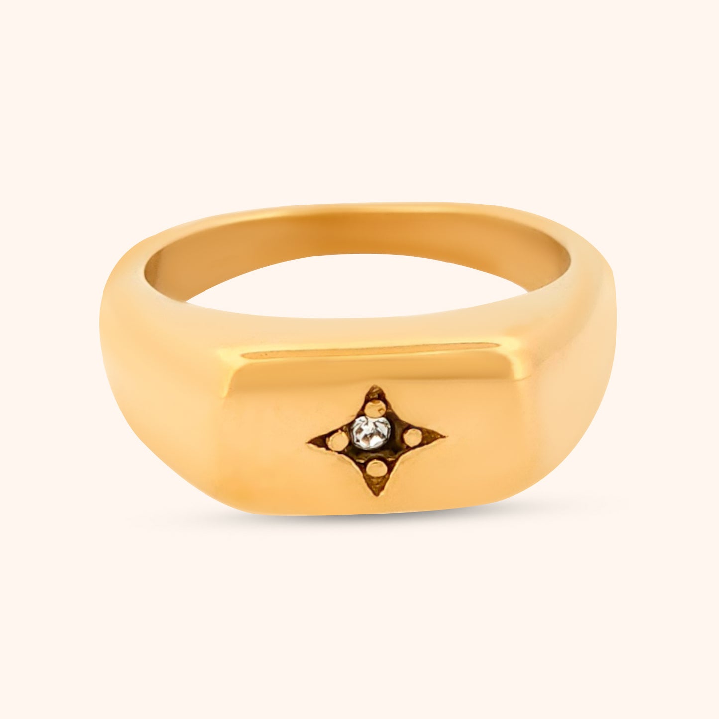 Close-up of the Buenos Aires Ring, showcasing its sleek rectangular top, delicate four-point celestial star with a dazzling CZ center, set on a polished gold band.
