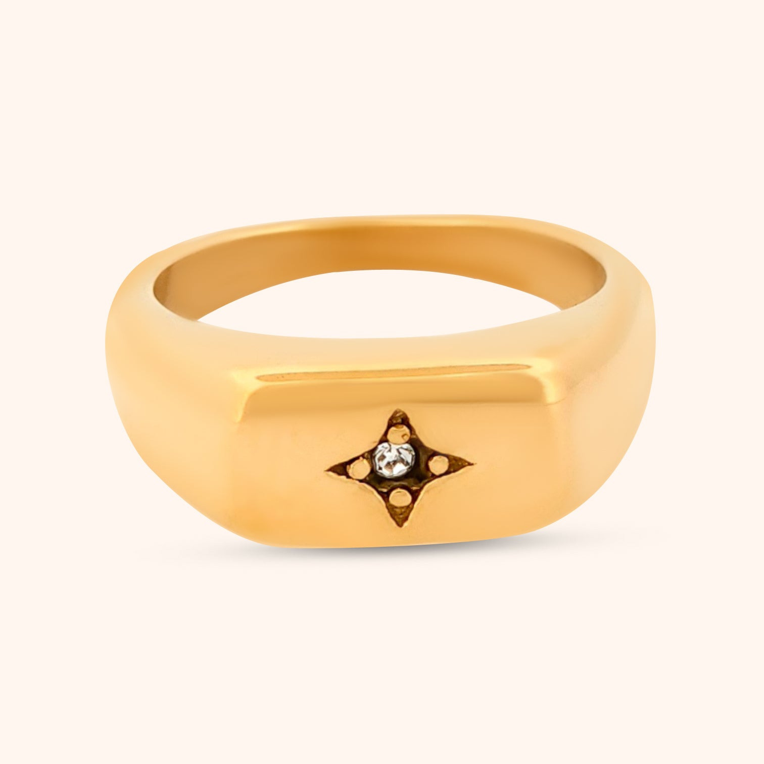 Close-up of the Buenos Aires Ring, showcasing its sleek rectangular top, delicate four-point celestial star with a dazzling CZ center, set on a polished gold band.
