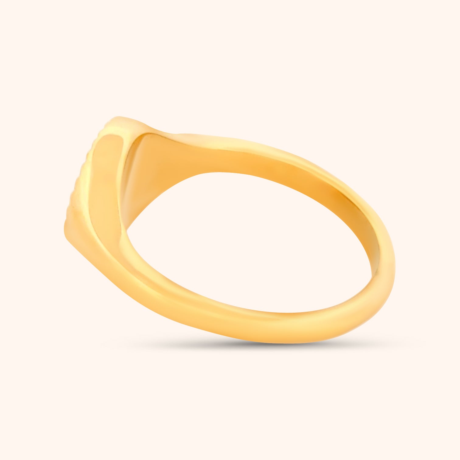 Angled view of the Helios Ring, highlighting the circular gold design with its sun-like radiating lines.