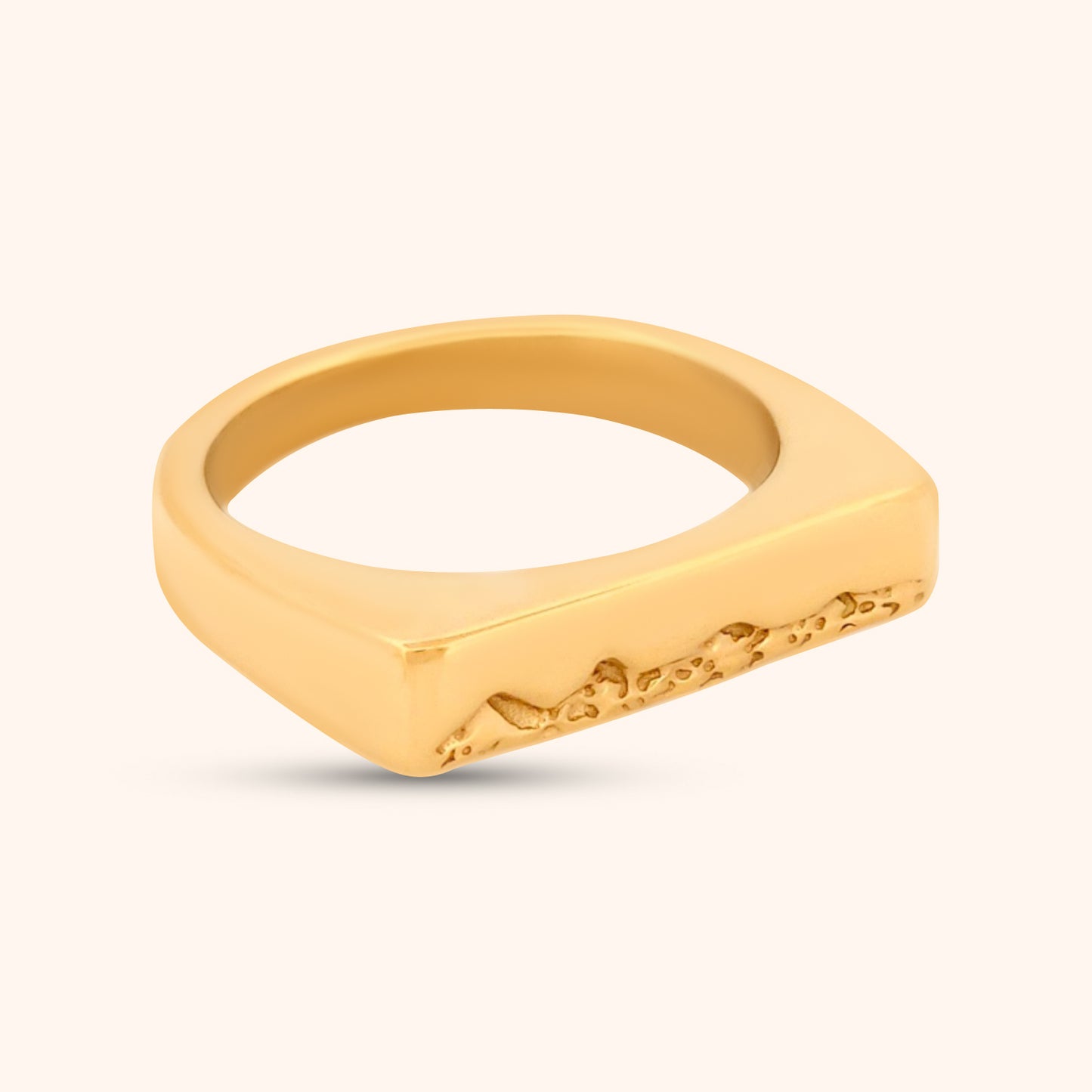 Angled view of the Kailua Ring, highlighting the clean lines of the gold band and the unique, engraved triangle mountain details on the rectangular top.
