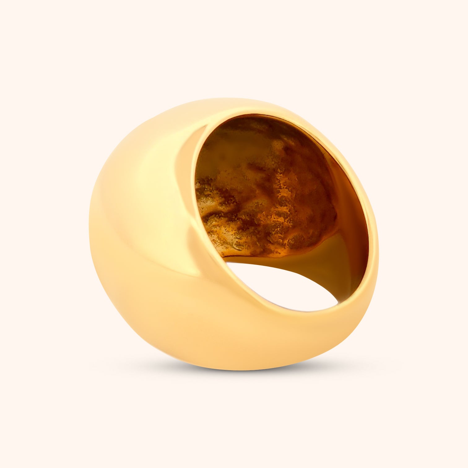The Dubai Ring demonstrating its modern and elegant design with a perfectly circular dome on a sleek gold band.