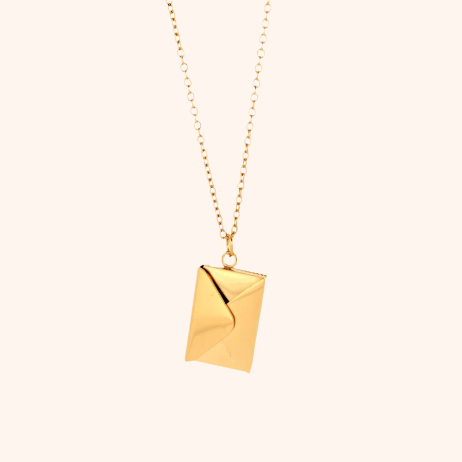 Close-up of a gold functional envelope necklace pendant, showcasing its detailed design and elegant style.
