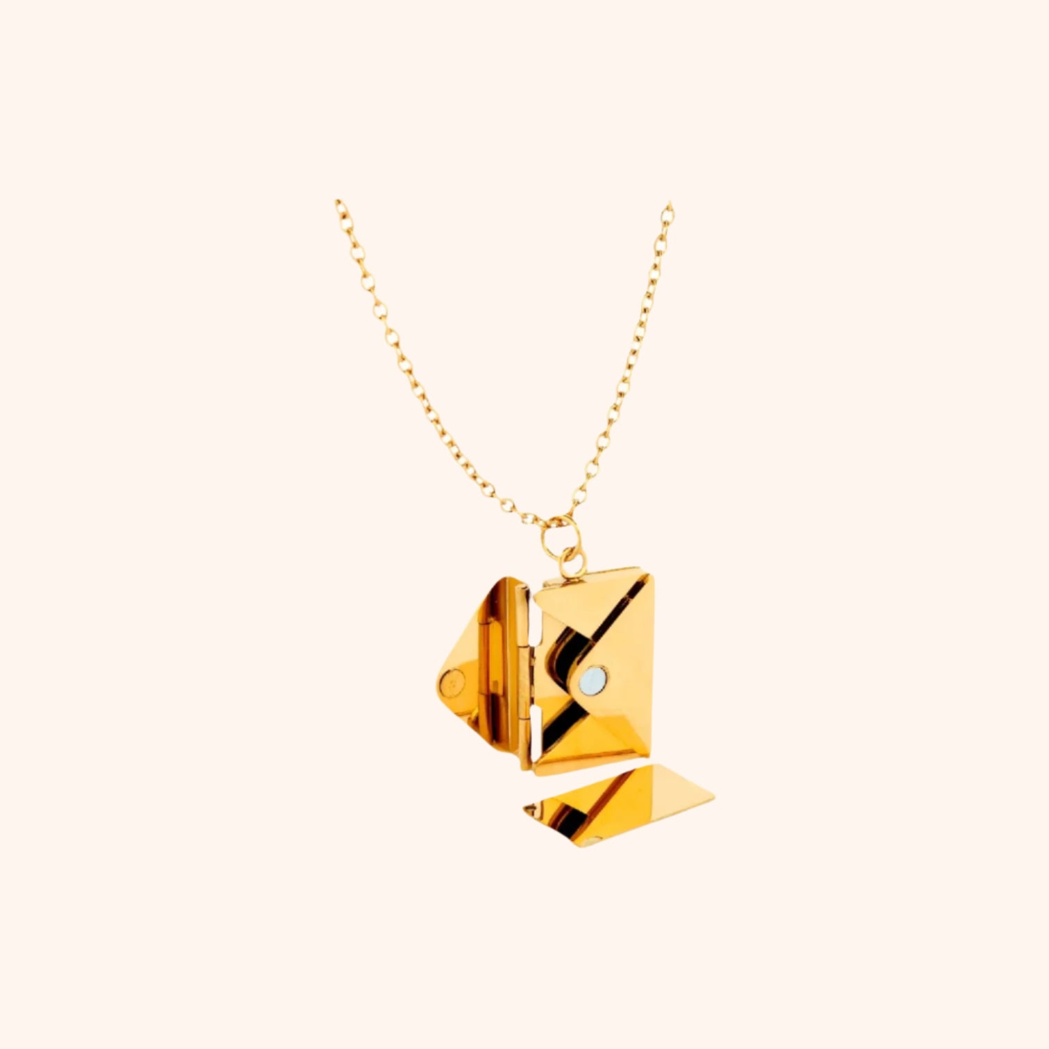 Gold functional envelope necklace laid flat, highlighting the delicate chain and the unique envelope pendant.
