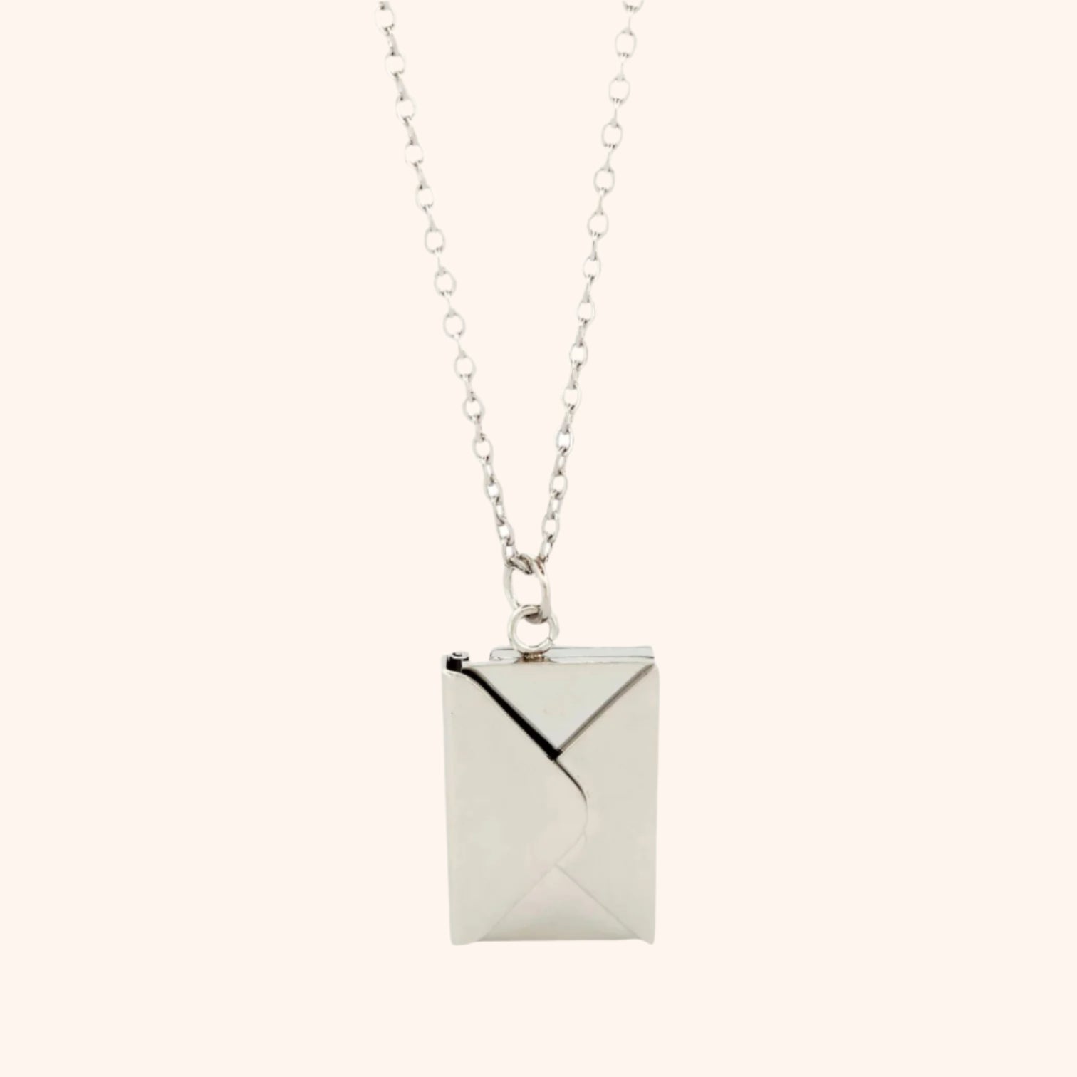 Close-up of a silver functional envelope necklace pendant, showcasing its detailed design and elegant style.
