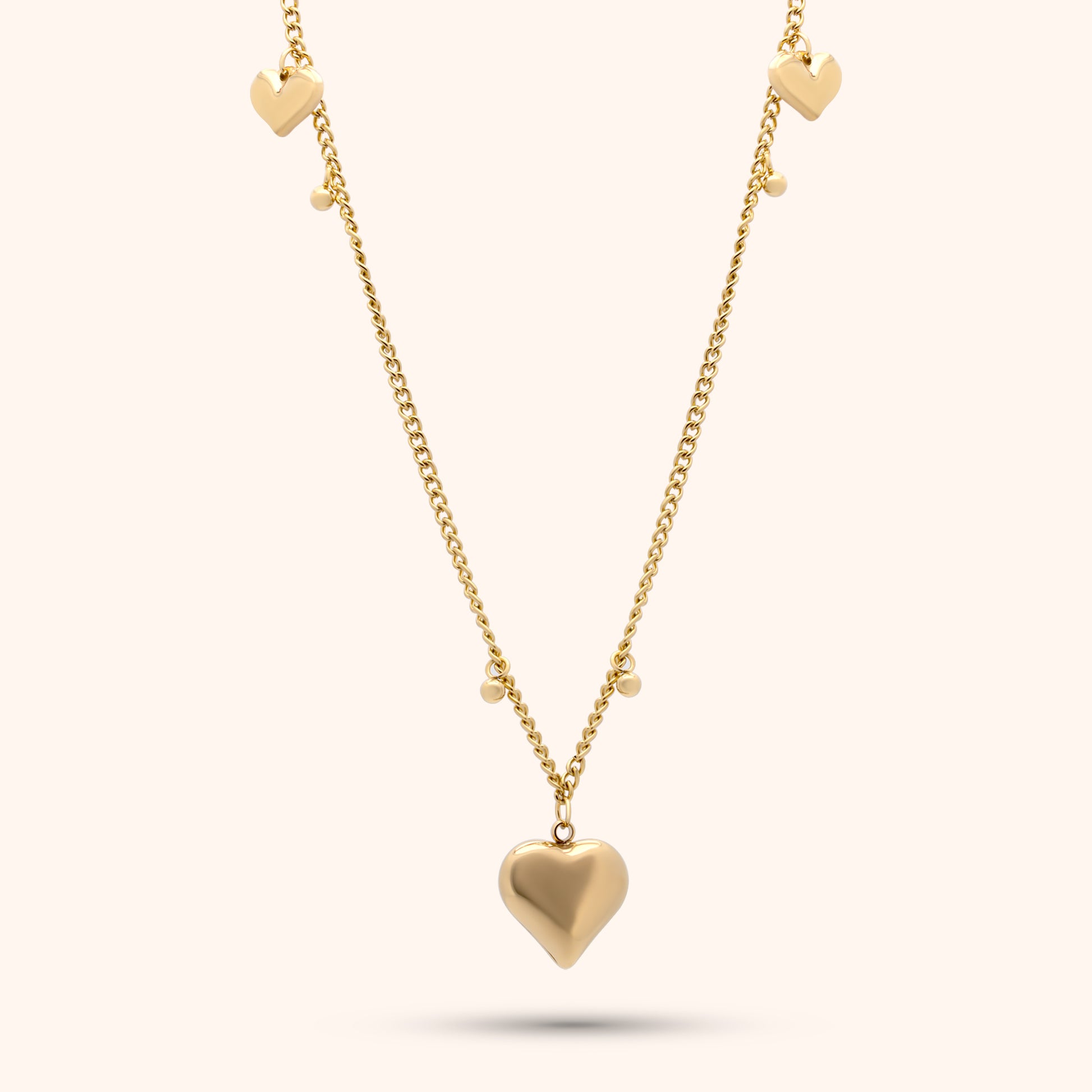 Pressie Delicate Symmetrical Heart Charm Necklace, 18K gold plated stainless steel, close-up of the heart charm details.