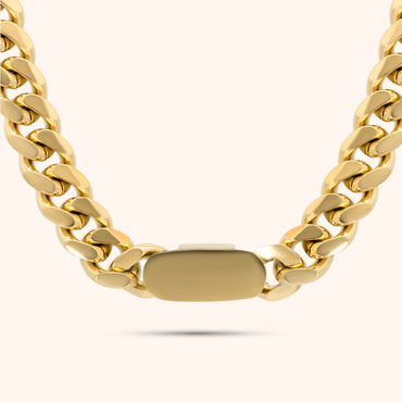 Close-up of the clasp on the PRESSIE Iconic Link Necklace; an 18k gold plated thick Cuban link chain with a smooth rectangular box clasp.