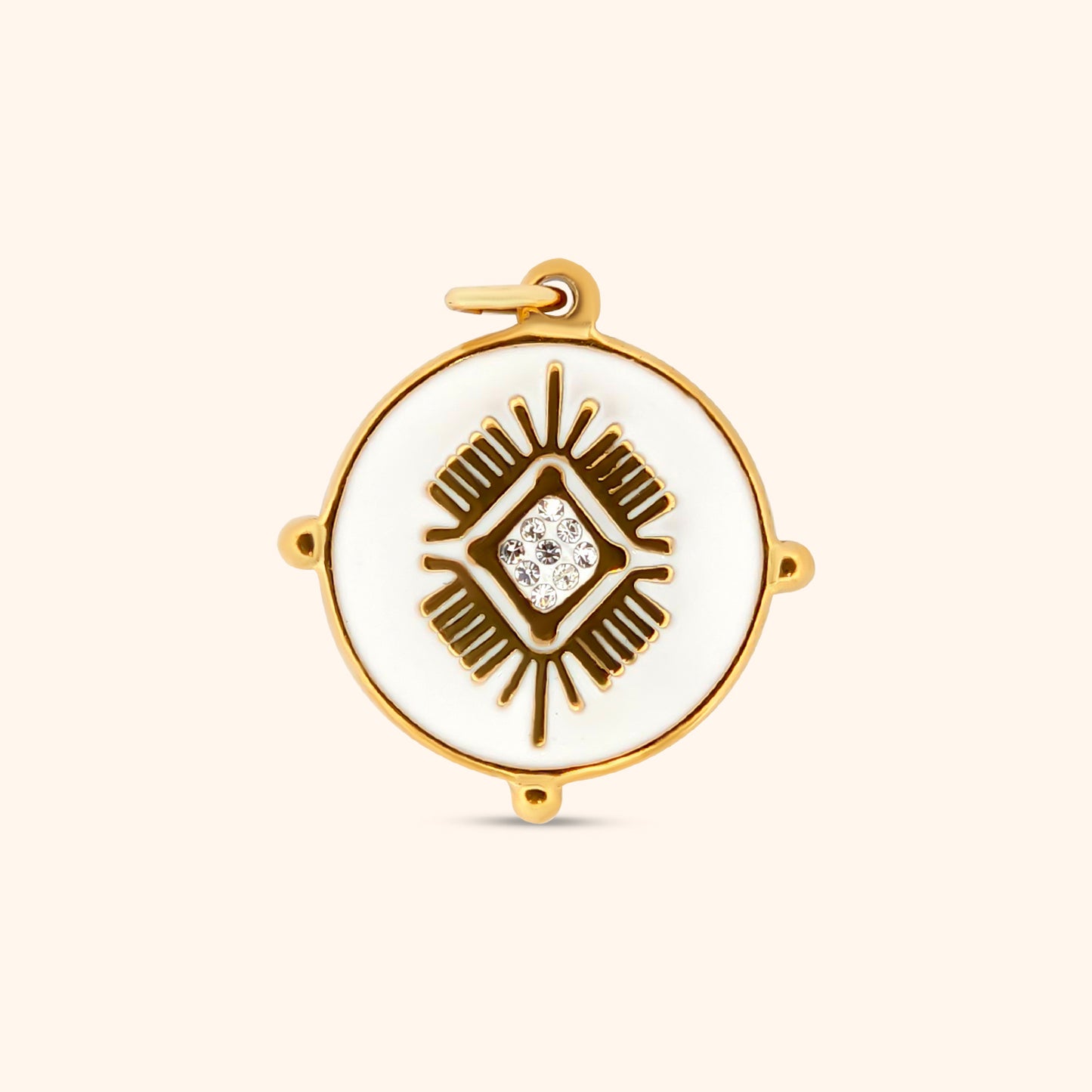 Close-up of the Andes Charm, a circular charm featuring white enamel and intricate gold detailing, inspired by Machu Picchu.