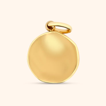rear view of the Celestial Charm, showcasing the texture and the circular shape of the gold charm.