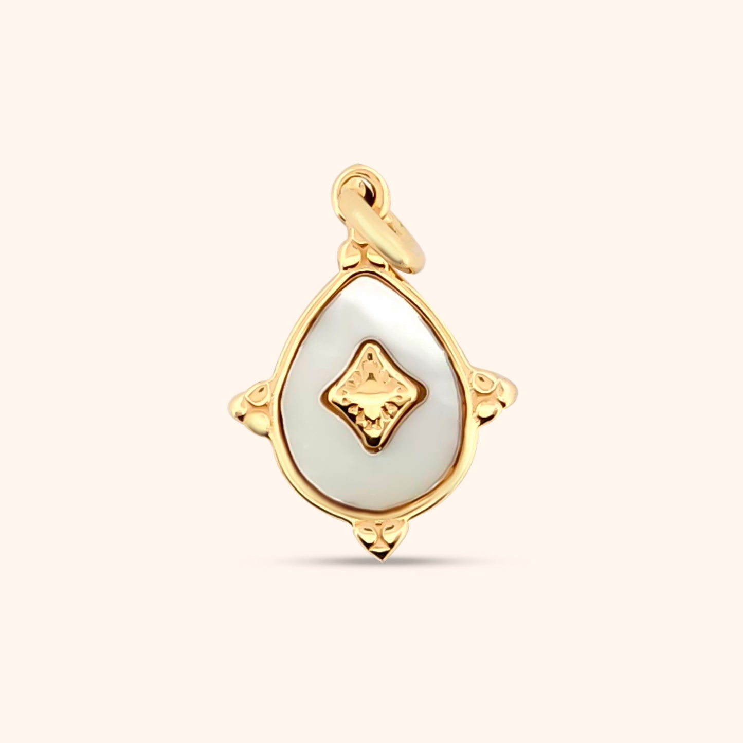 Close-up of the Luminescence Charm, a teardrop-shaped charm featuring a mother-of-pearl inlay and gold detailing.