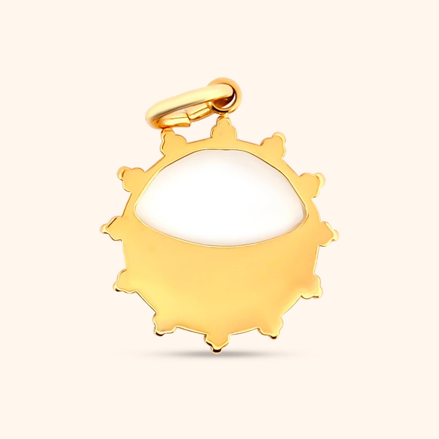 Rear view of the Solstice Sun Charm, showcasing the gold sunburst design, the iridescence of the mother-of-pearl, and the charm's circular shape.