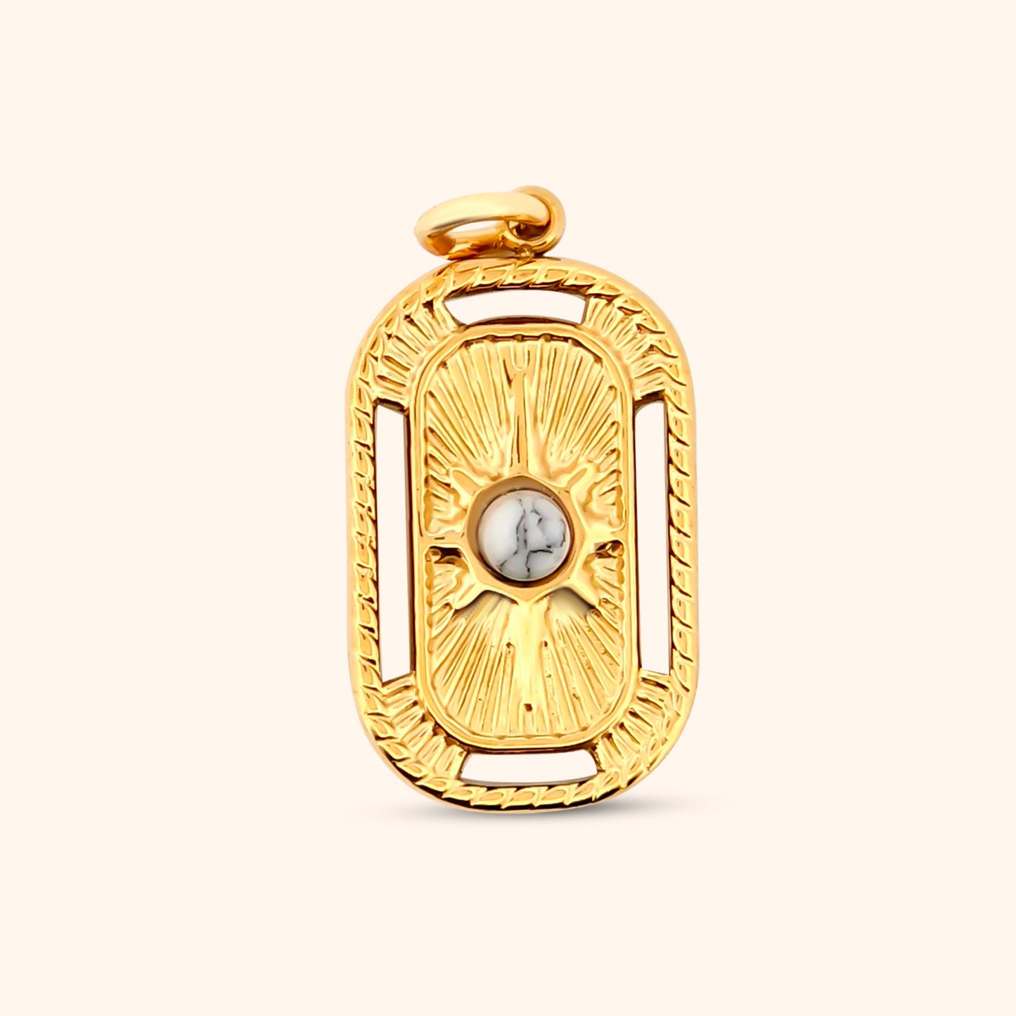 Close-up of the Savanna Charm, a rectangular gold charm featuring intricate star details and a textured border.