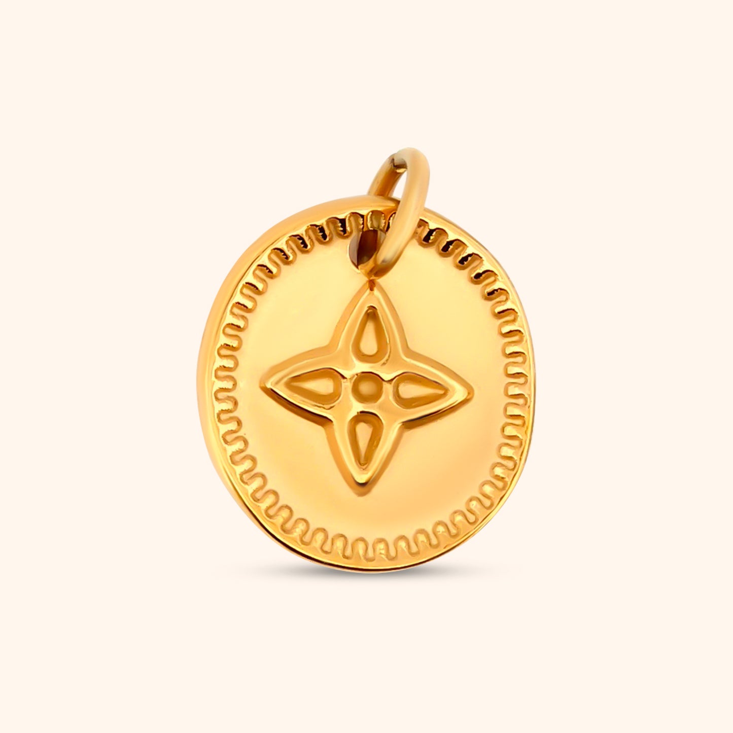 Close-up of the Solara Charm, a dainty oval-shaped gold charm featuring a four-point star design.