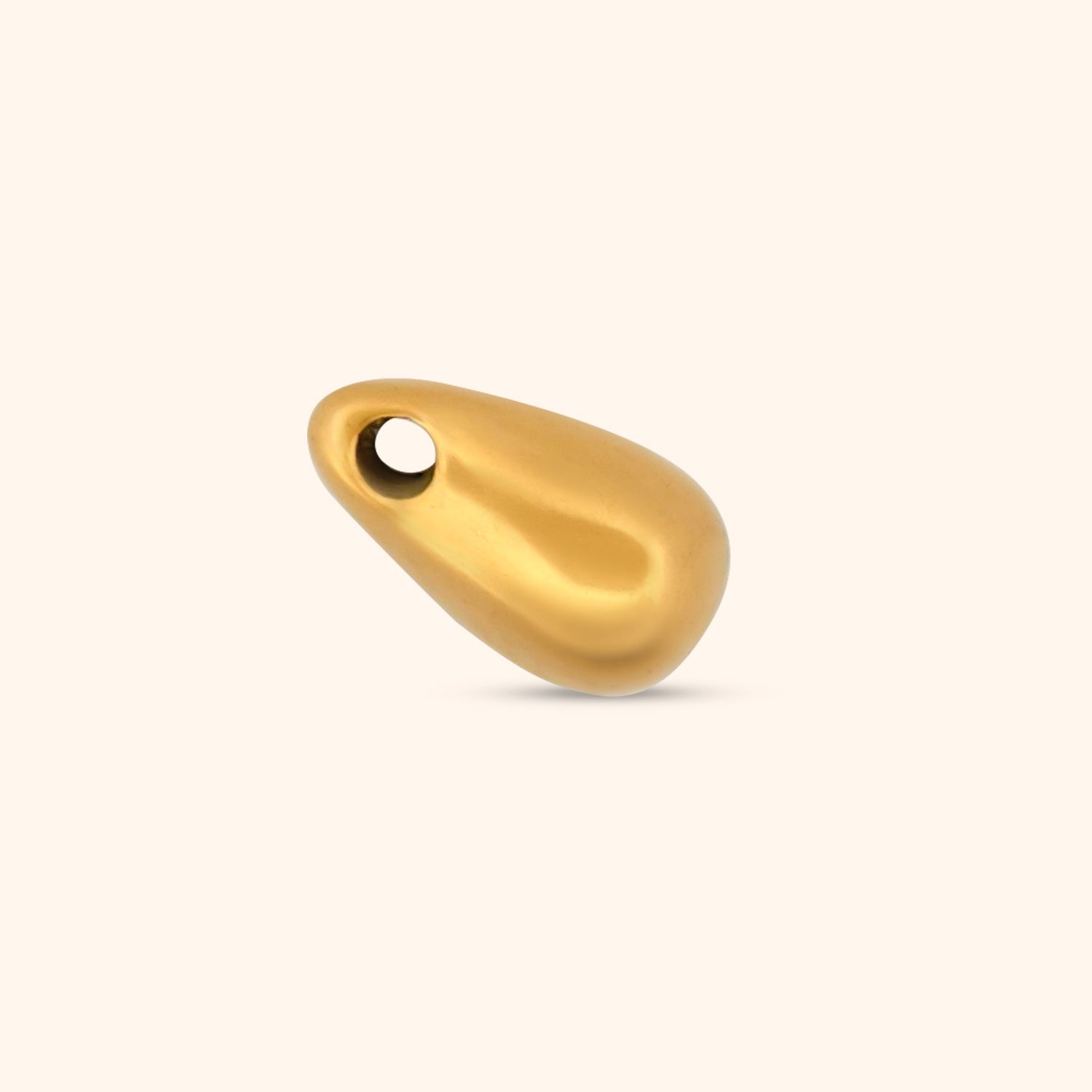 Close-up of the Cascade Charm, a gold teardrop-shaped charm with a threader design.