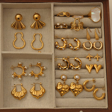 Pressie Celestial Starburst Huggie Hoop Earrings along with a collection of other earrings and rings