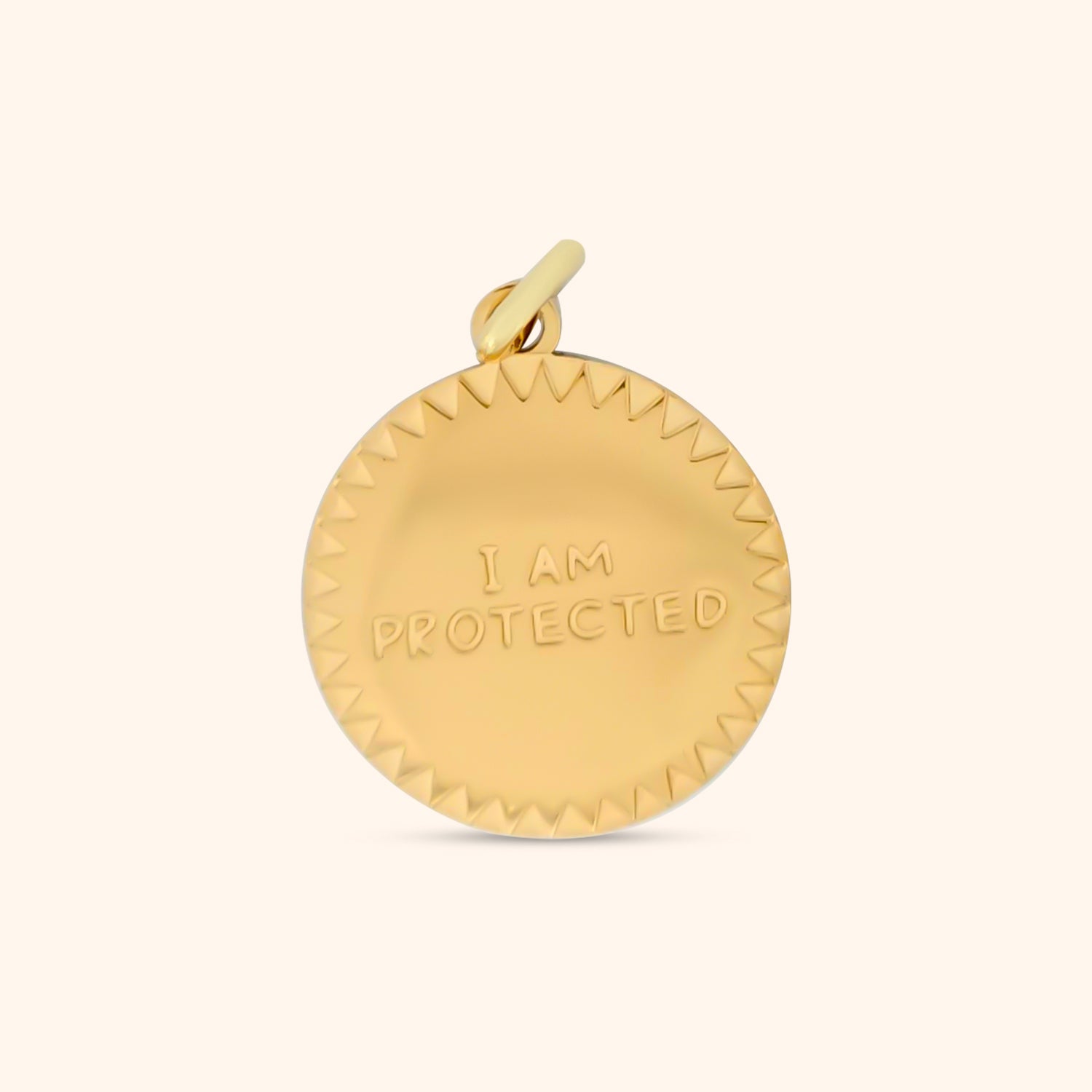 Close-up of the Aegis Charm, a gold charm engraved with the words 'I Am Protected'.