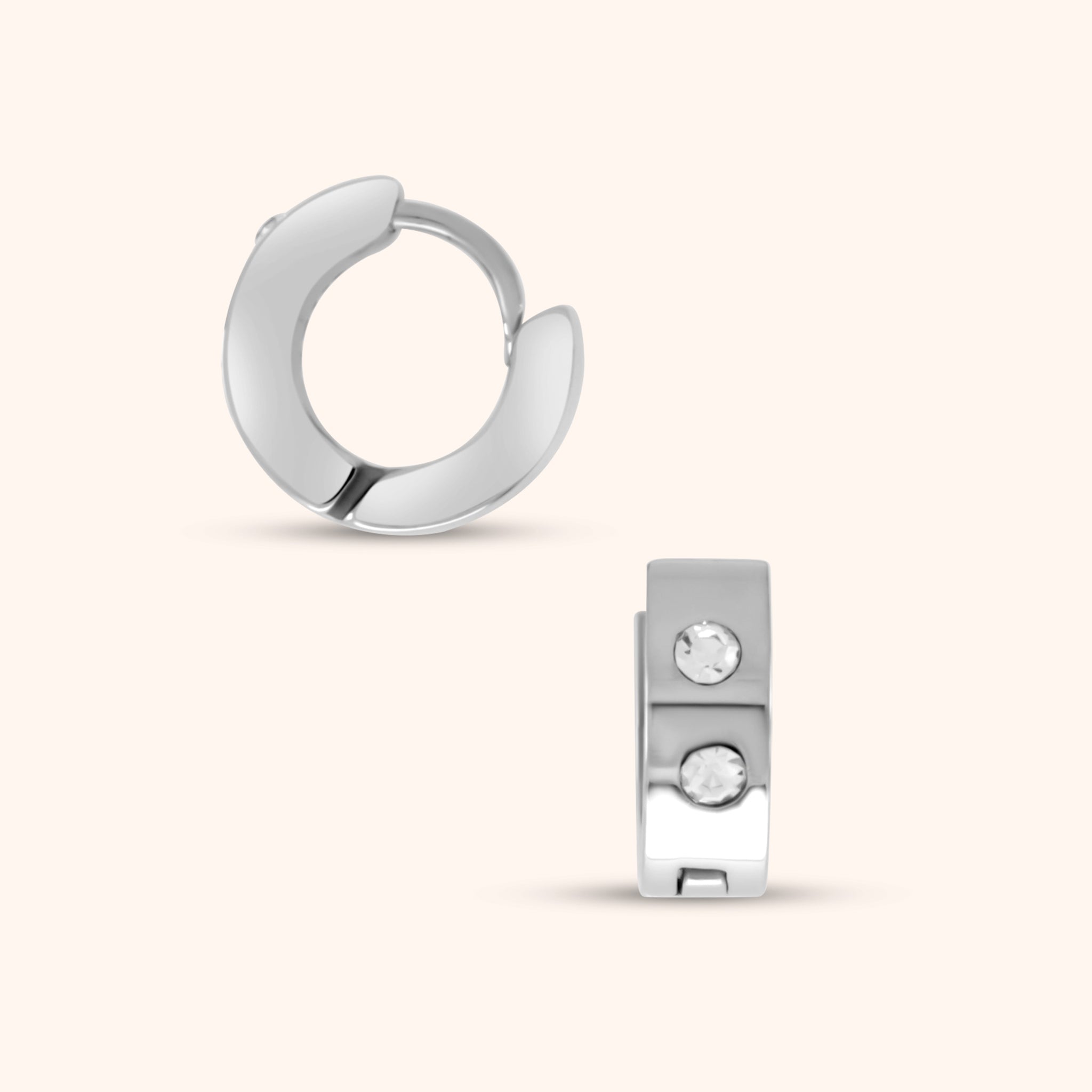 Extreme close-up of a single PRESSIE Aperture Hoop earring, clearly showing the hinge mechanism and the two small, clear, round stones set on the front of the 14k gold-plated hoop.