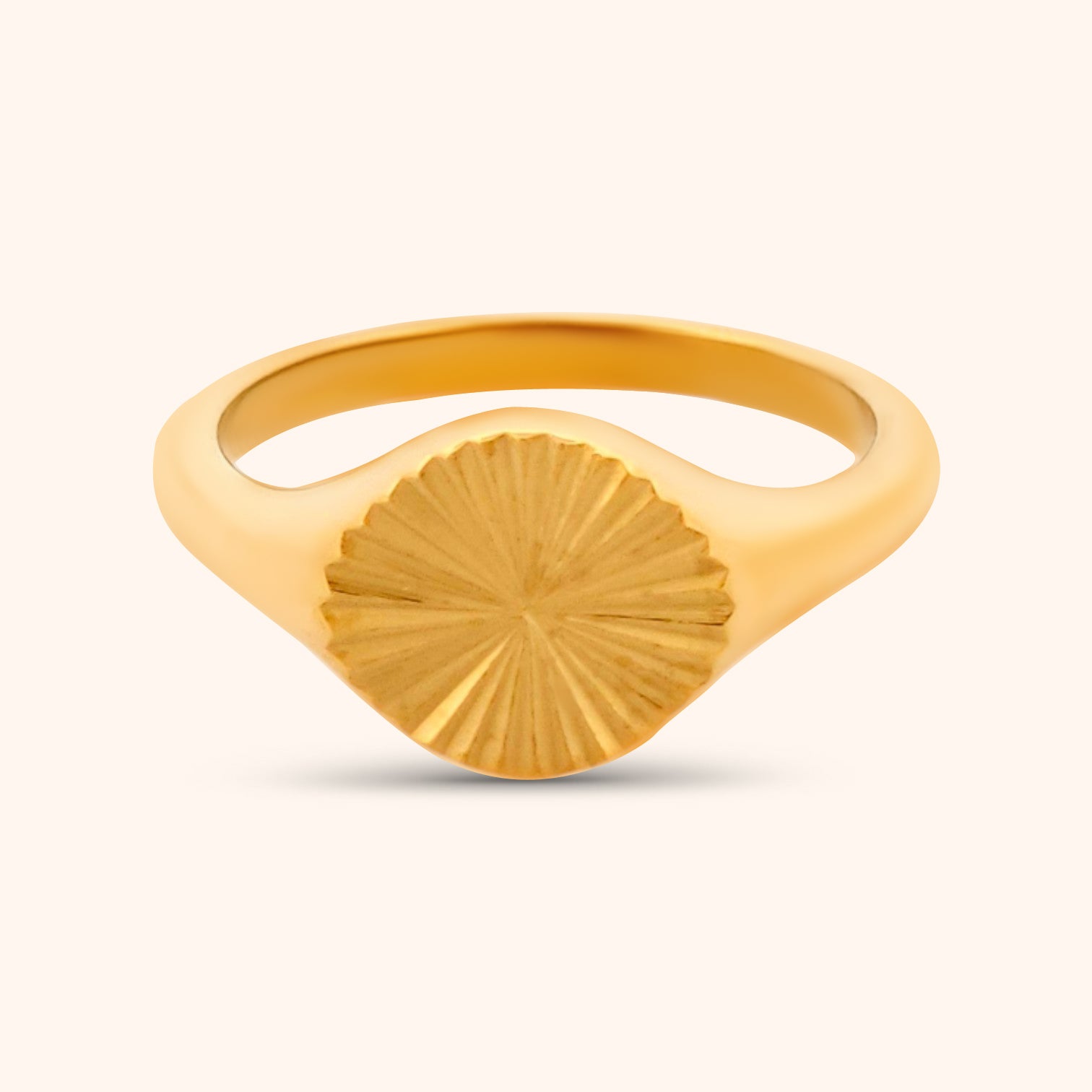 Close-up of the Helios Ring, a gold ring featuring a circular design with radiating lines, resembling a stylized sun.