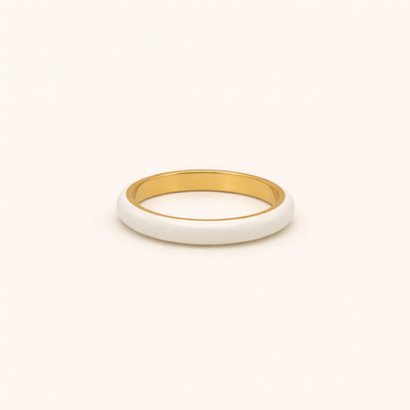 Gold and white ring on a beige background