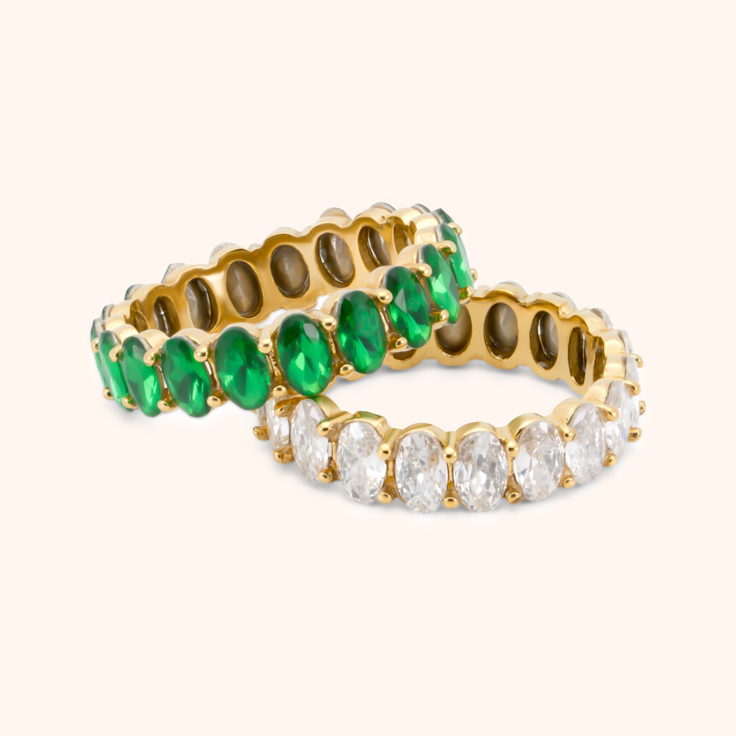 Gold eternity ring with oval-cut emerald green stones in full circle setting, made of 18k gold plated stainless steel