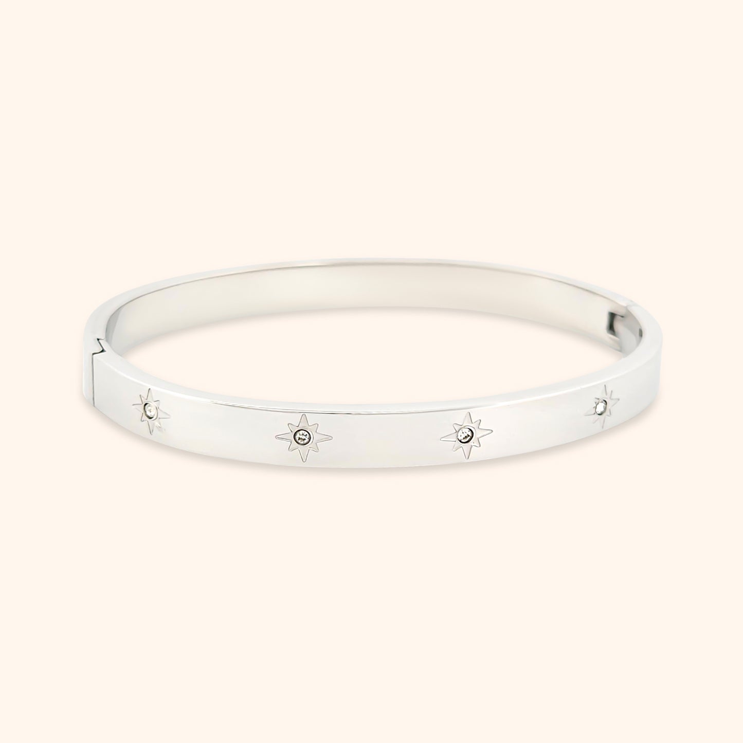 Close-up of the Starry Night Bangle Bracelet, showcasing its delicate star motifs adorned with sparkling crystals set against a sleek gold band.
