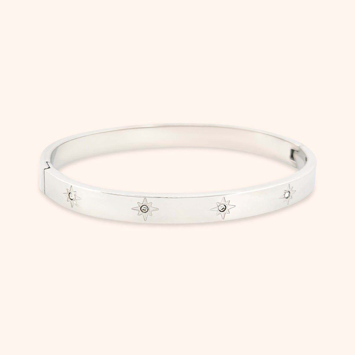 Close-up of the Starry Night Bangle Bracelet, showcasing its delicate star motifs adorned with sparkling crystals set against a sleek gold band.
