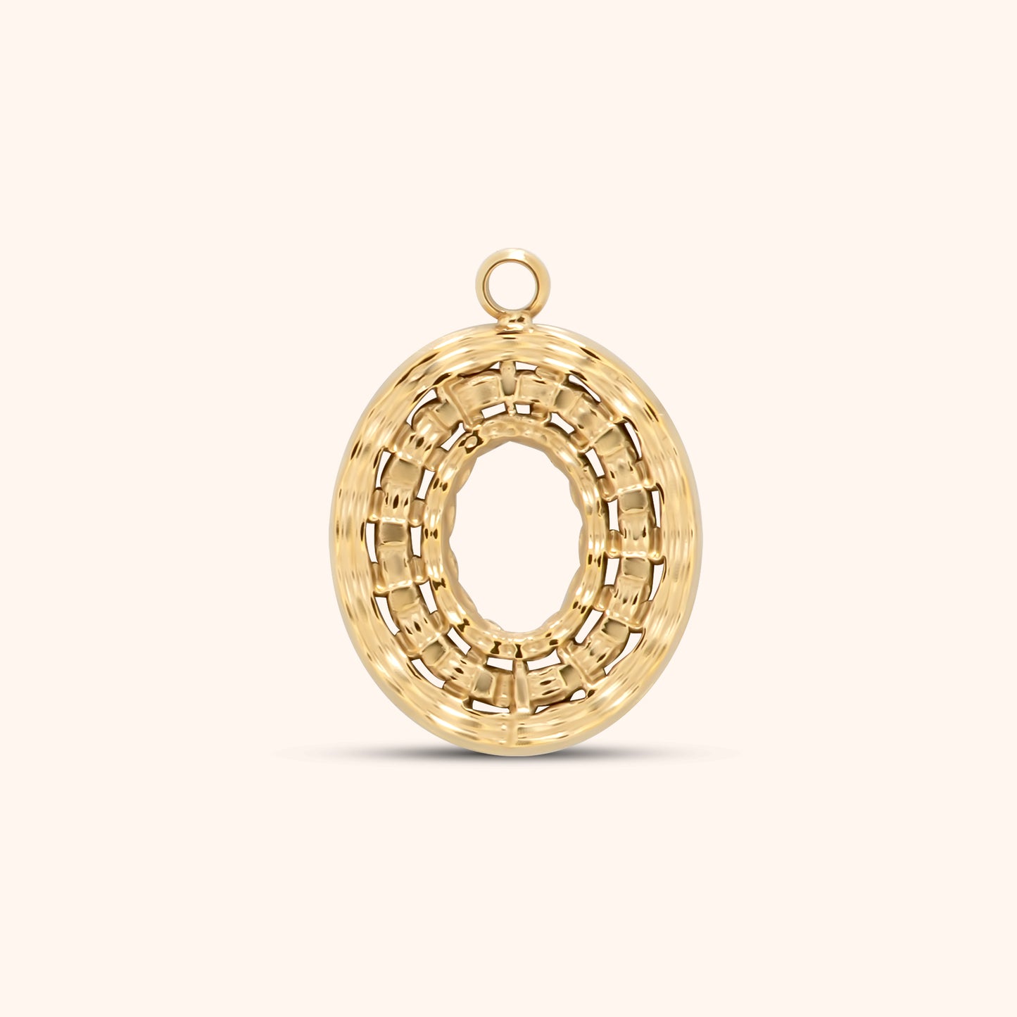 Textured oval gold charm with a woven basket-like pattern and an open center, featuring a top loop for attaching to necklaces or bracelets