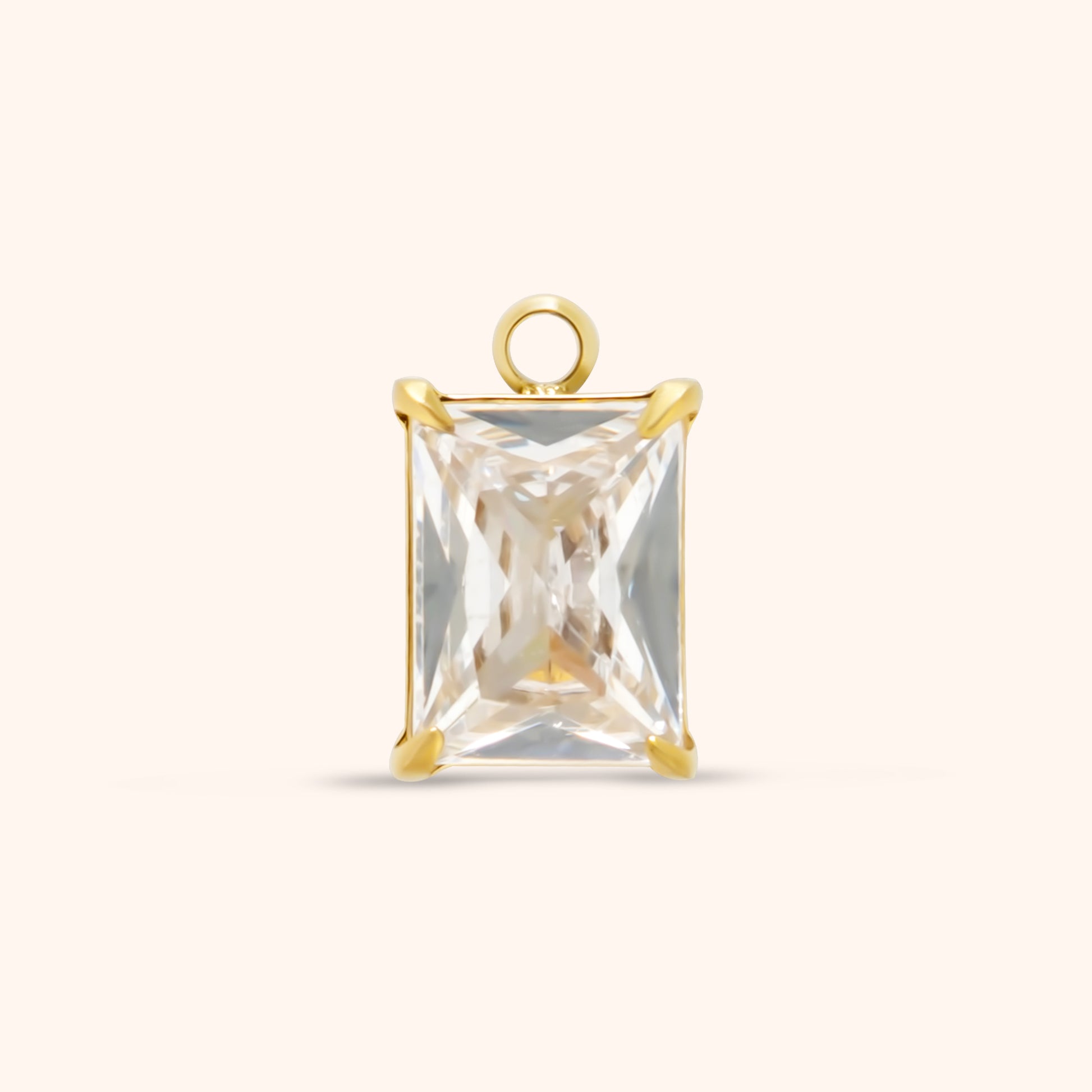 Rectangular faceted clear gemstone charm set in gold with prong corners and a top loop, made of 18k gold plated stainless steel