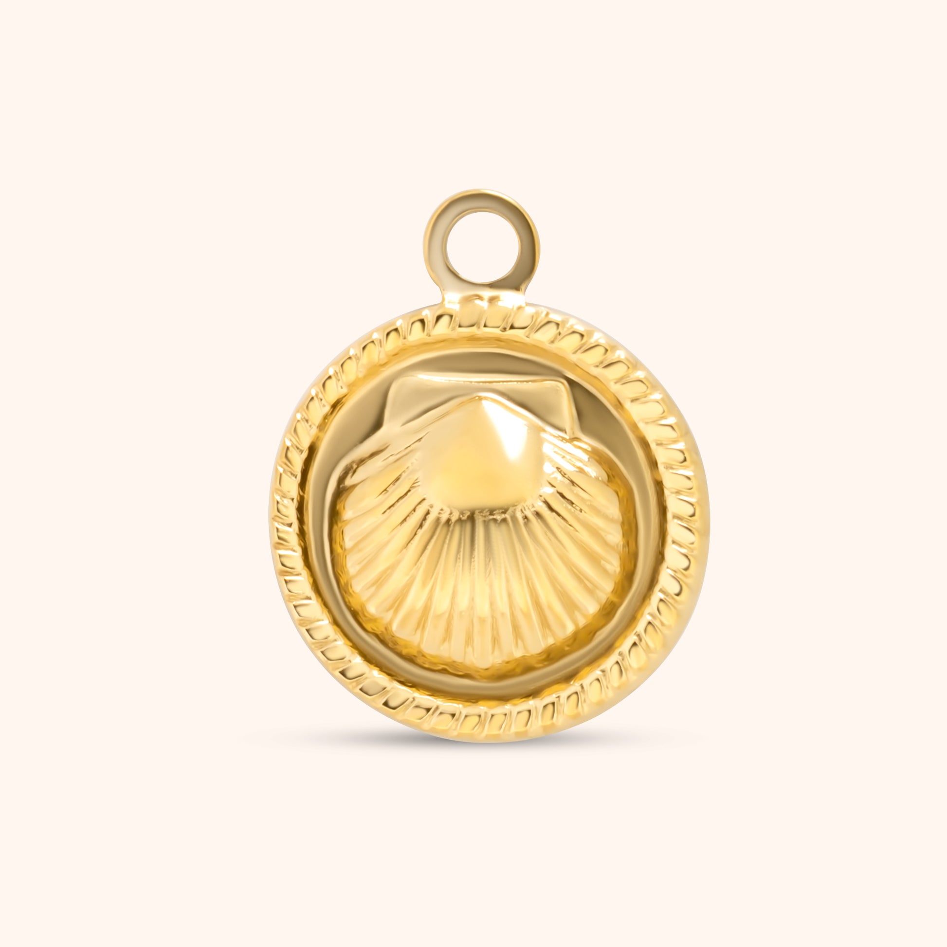 PRESSIE Seashore Charm; an 18k gold plated round charm featuring a detailed scallop shell design with a textured rope border.