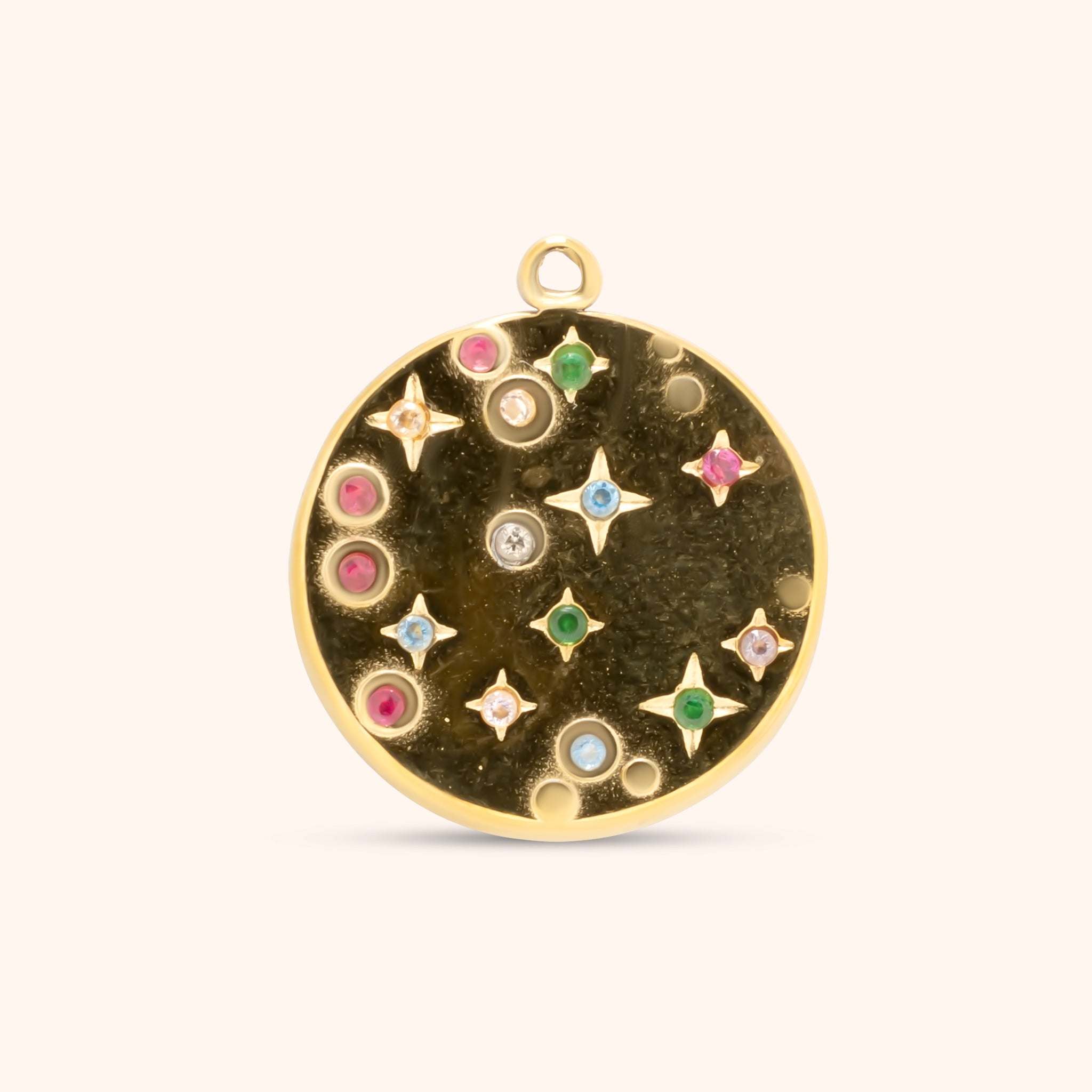 PRESSIE Cosmic Charm; an 18k gold plated round disc charm with a textured background, adorned with gold stars and various small, colorful, bezel-set and star-set gemstones depicting a starry sky.