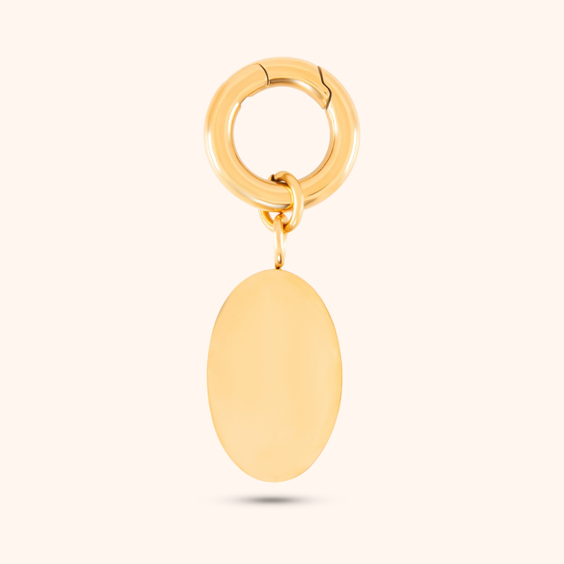 Close-up, rear view of a PRESSIE gold-plated, oval-shaped pendant showing its smooth texture.