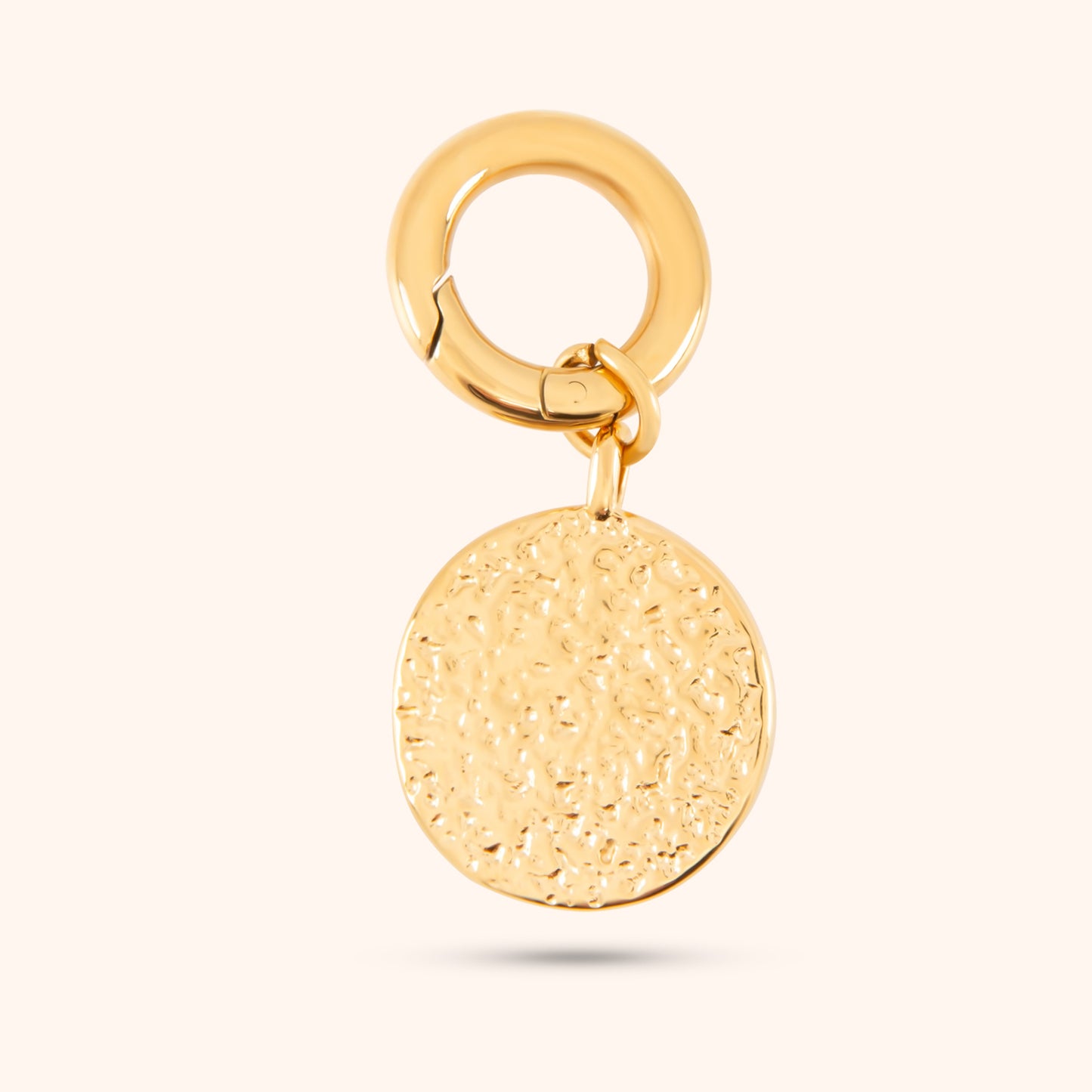 Angled view of the Luna Charm, a gold charm with a detailed moon and star design, showcasing the pearls, cubic zirconia accents, and small hoop for attachment.