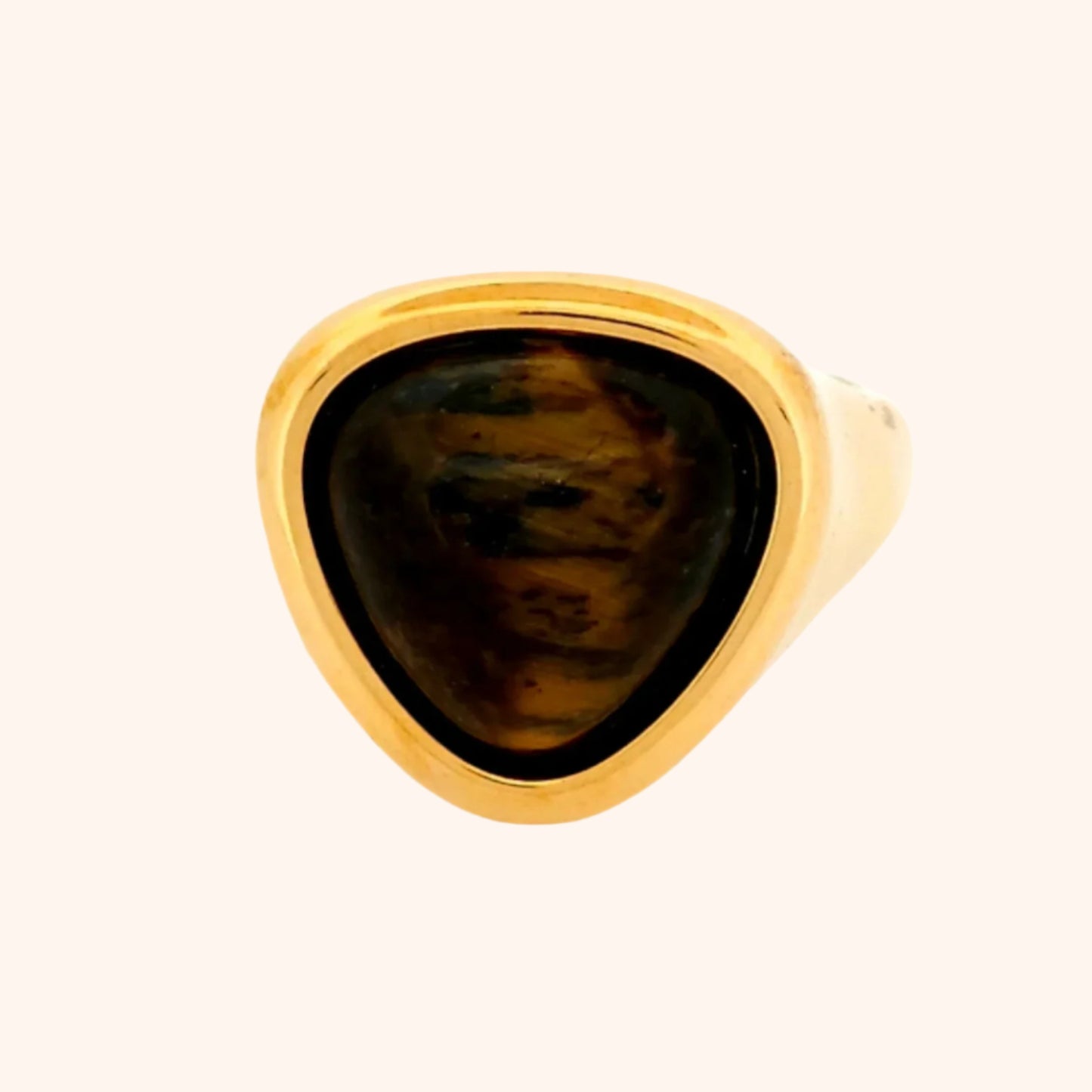 Close-up of the Idar Ring, a gold ring featuring a Tiger's Eye gemstone, showcasing its golden shimmer and unique chatoyancy.

