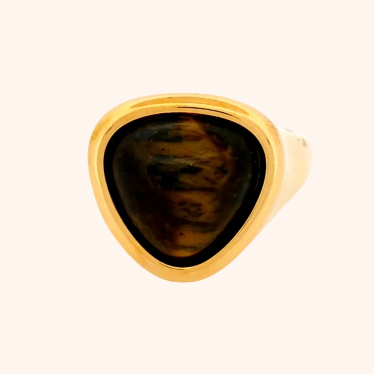 Close-up of the Idar Ring, a gold ring featuring a Tiger's Eye gemstone, showcasing its golden shimmer and unique chatoyancy.
