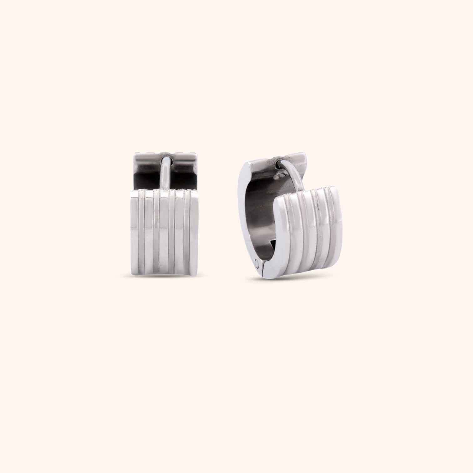 Pair of gold ribbed huggie earrings, highlighting their elegant and modern style.
