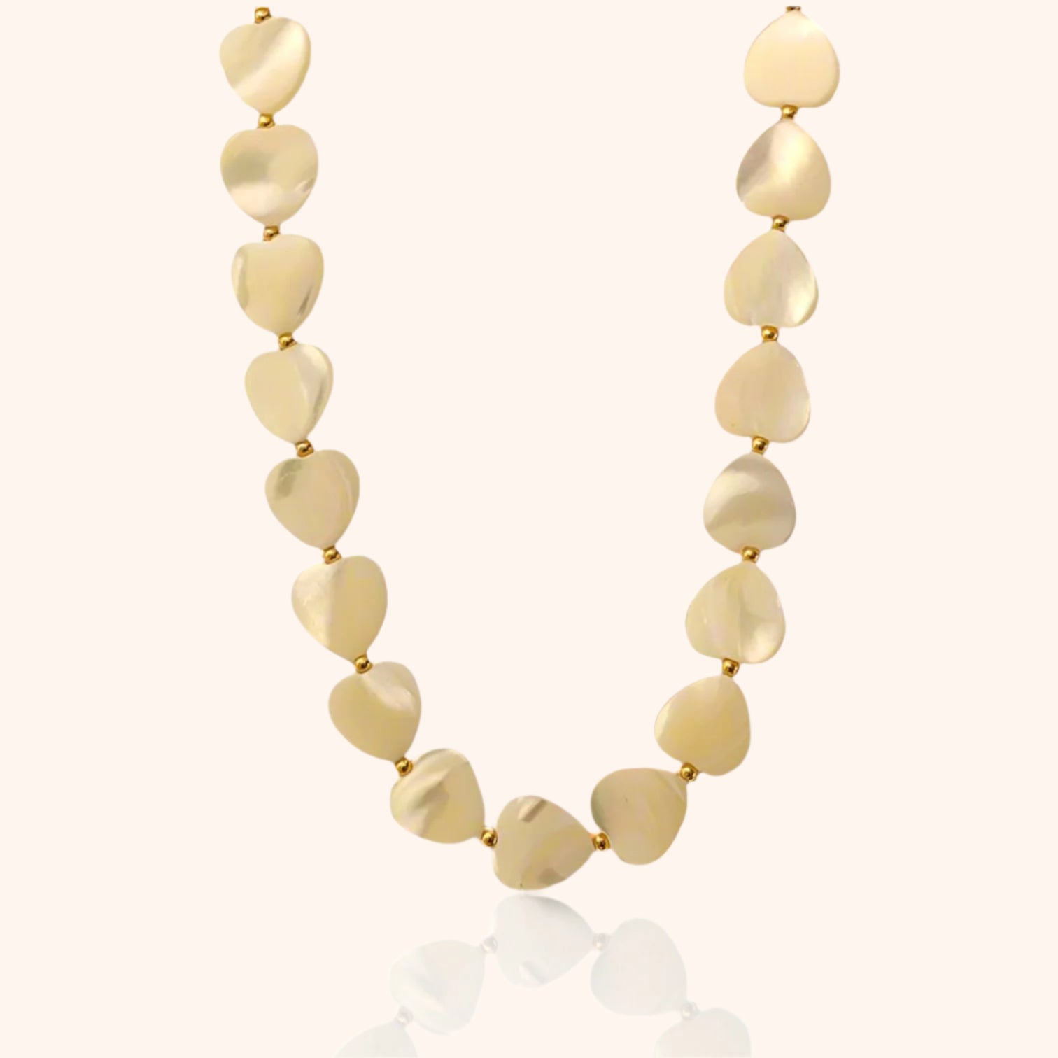 Close-up of a Mother of Pearl Heart Necklace featuring delicate, heart-shaped mother-of-pearl beads with a soft, iridescent glow.
