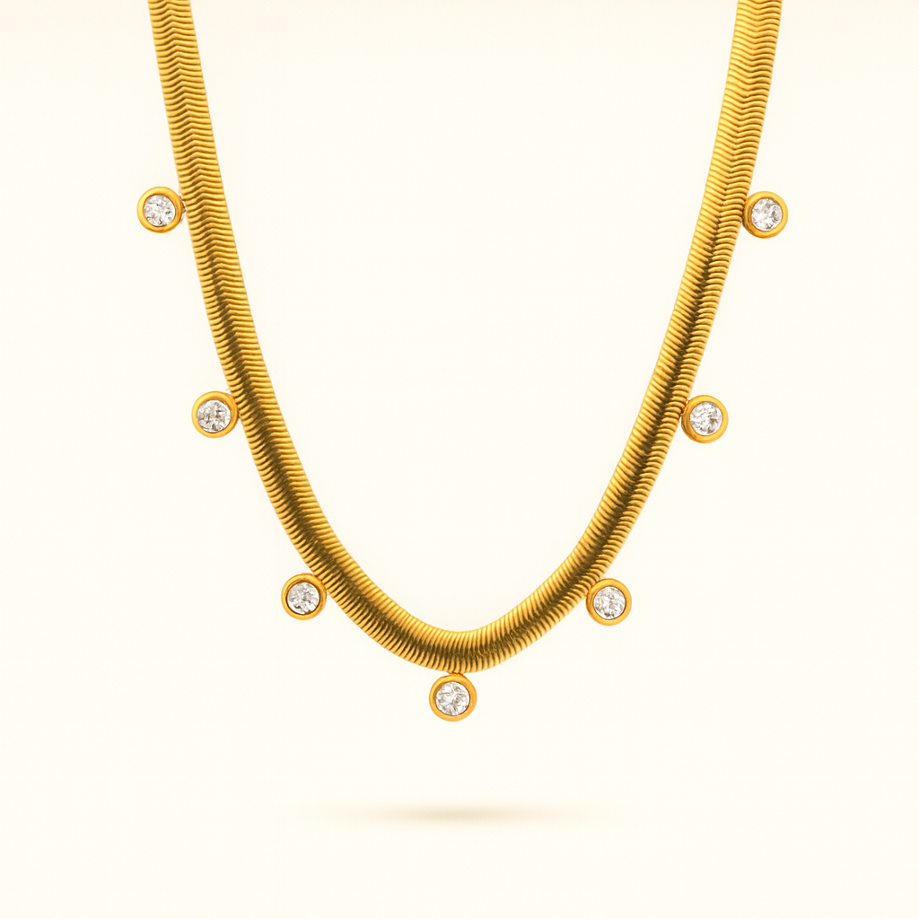 Gold necklace with embedded diamonds on a light beige background