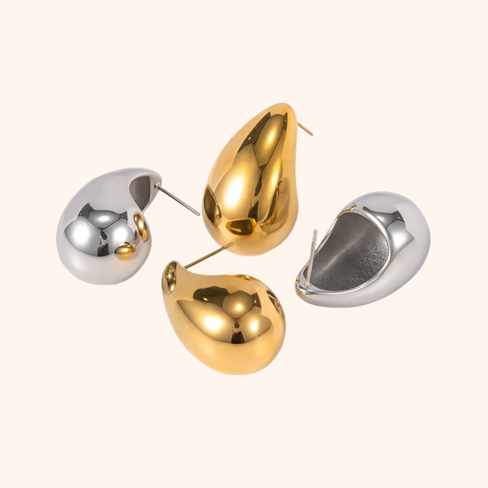 Pair of gold and silver teardrop earrings, demonstrating their versatile style and modern chic design.
