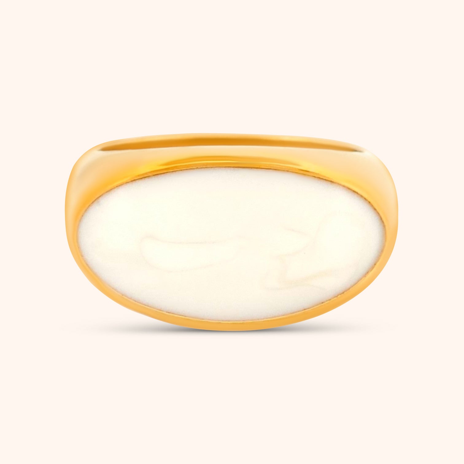 Close-up of The Jaipur Ring, a gold ring featuring a sideways oval Malachite gemstone, showcasing its vibrant green bands and unique patterns.
